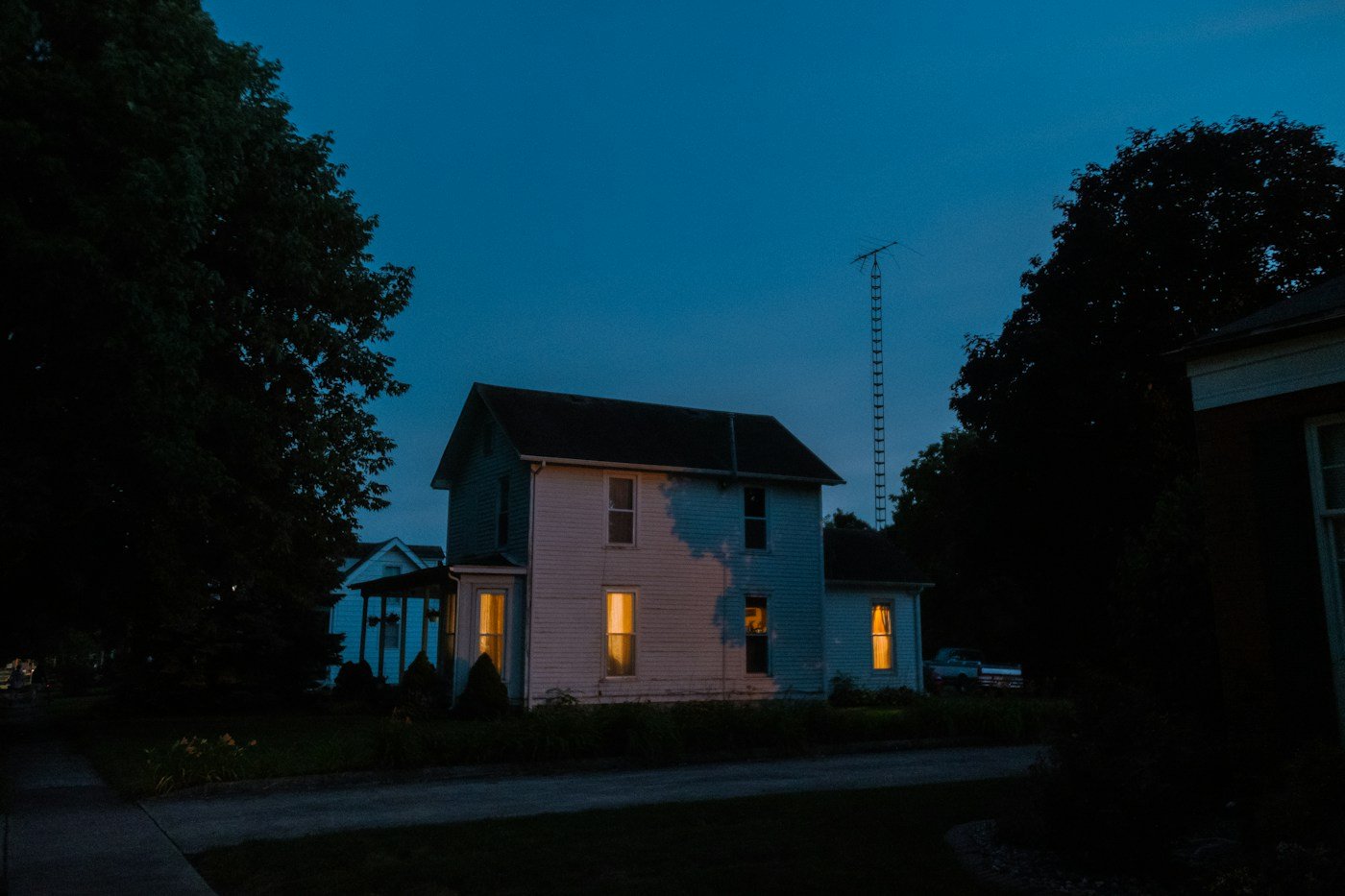 A home at night with warm lights on inside